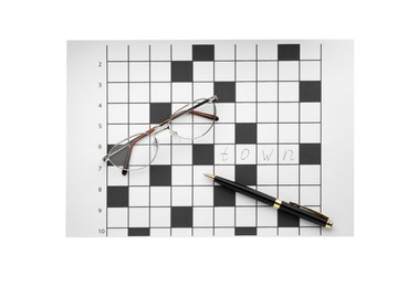 Blank crossword, eyeglasses and pen on white background, top view