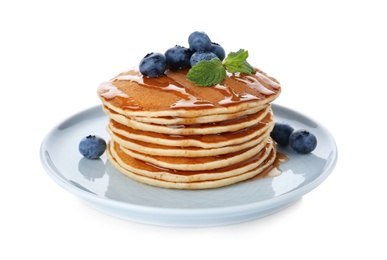 Photo of Plate with stack of tasty pancakes and fresh berries on white background