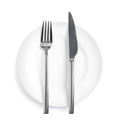 Photo of Clean plate with shiny cutlery on white background, top view