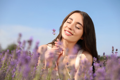 Photo of Young woman in lavender field on summer day