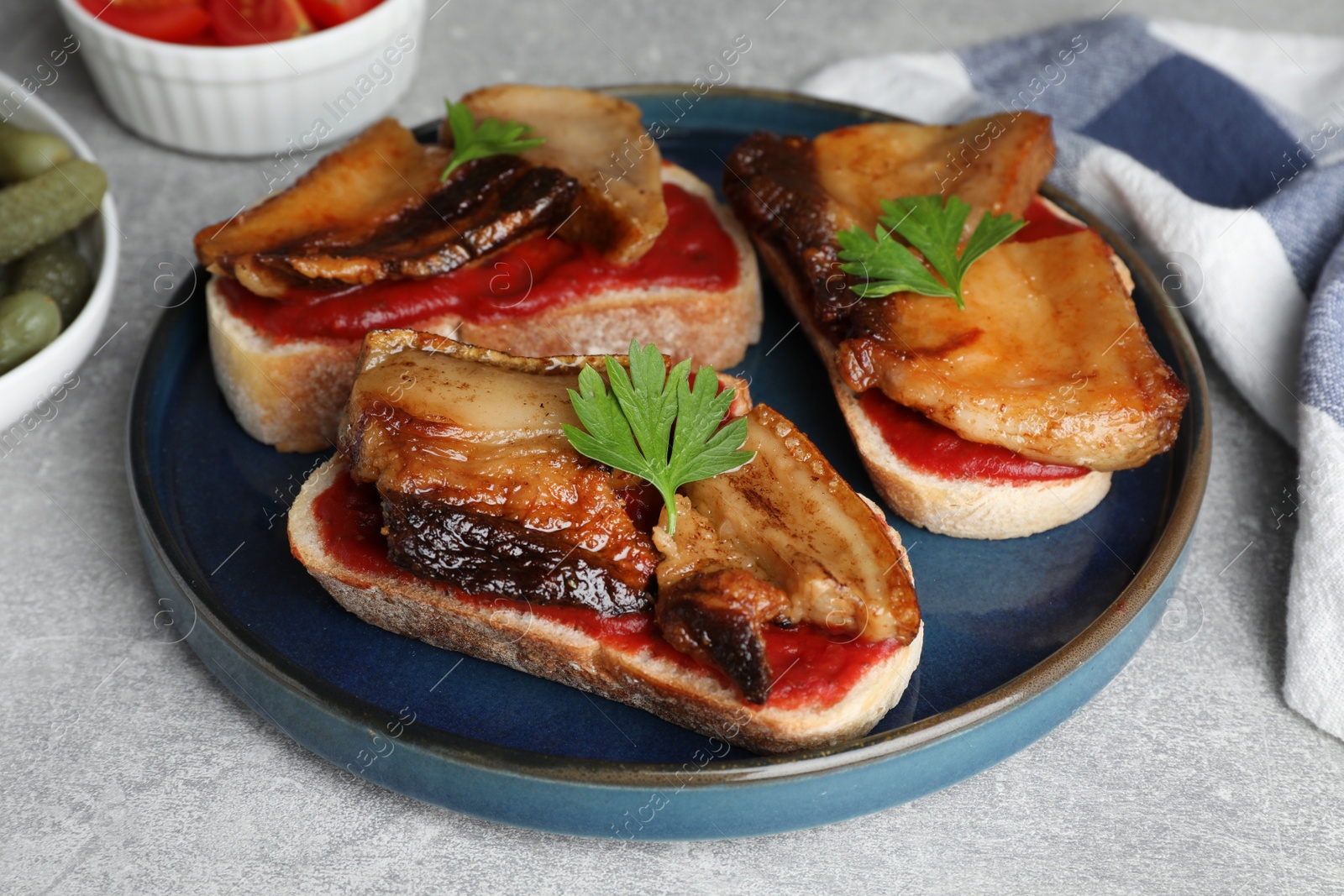 Photo of Tasty sandwiches with fried pork fatback slices on light grey table