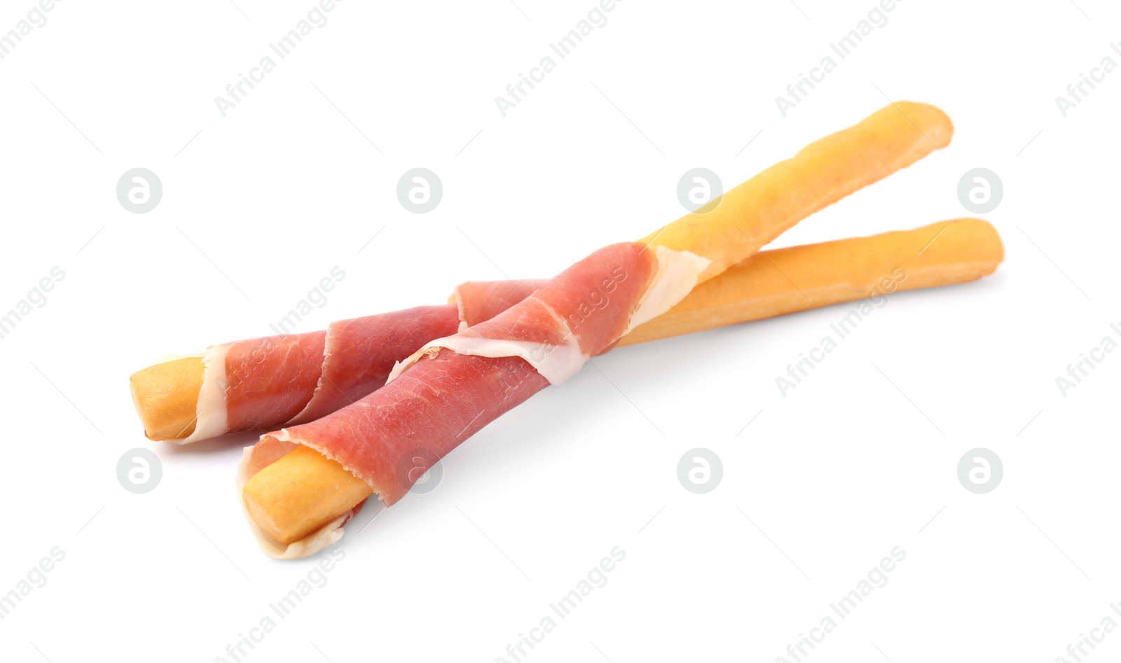 Photo of Delicious grissini sticks with prosciutto on white background