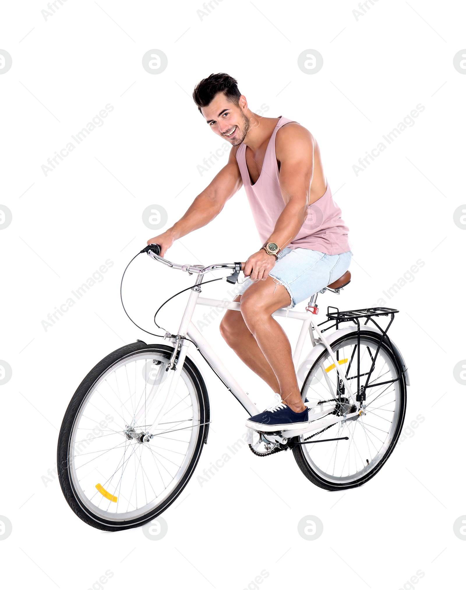 Photo of Handsome young hipster man riding bicycle on white background