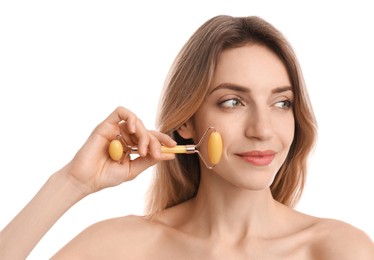 Photo of Young woman using natural jade face roller on white background