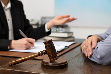 Photo of Senior man having meeting with lawyer in office, closeup