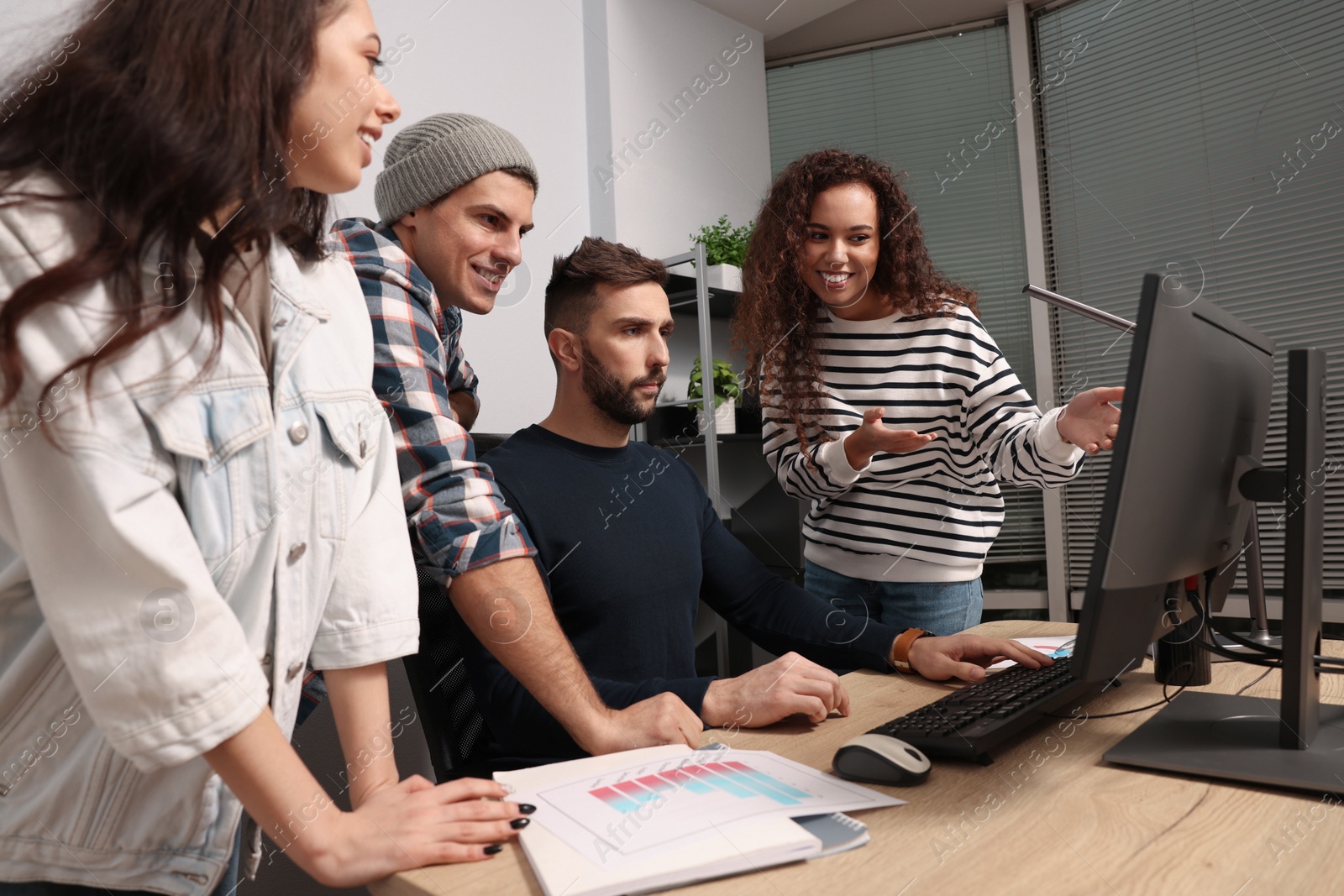 Photo of Team of employees working together in office. Startup project