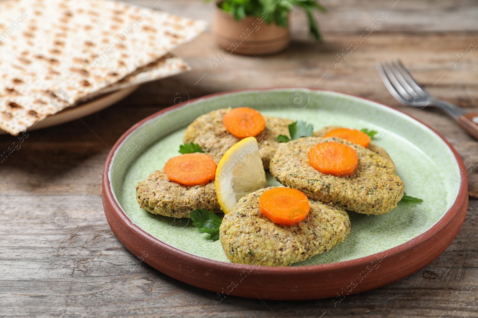 Photo of Plate of traditional Passover (Pesach) gefilte fish on wooden table, closeup