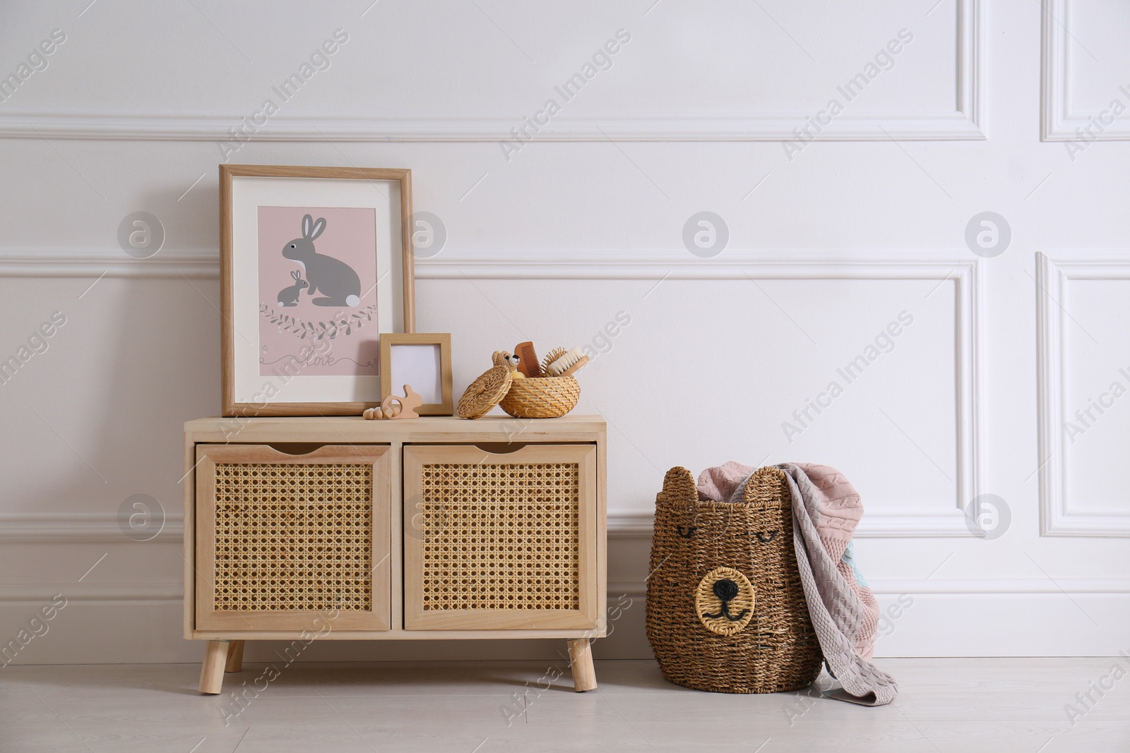 Photo of Modern child room interior with wooden cabinet and different accessories