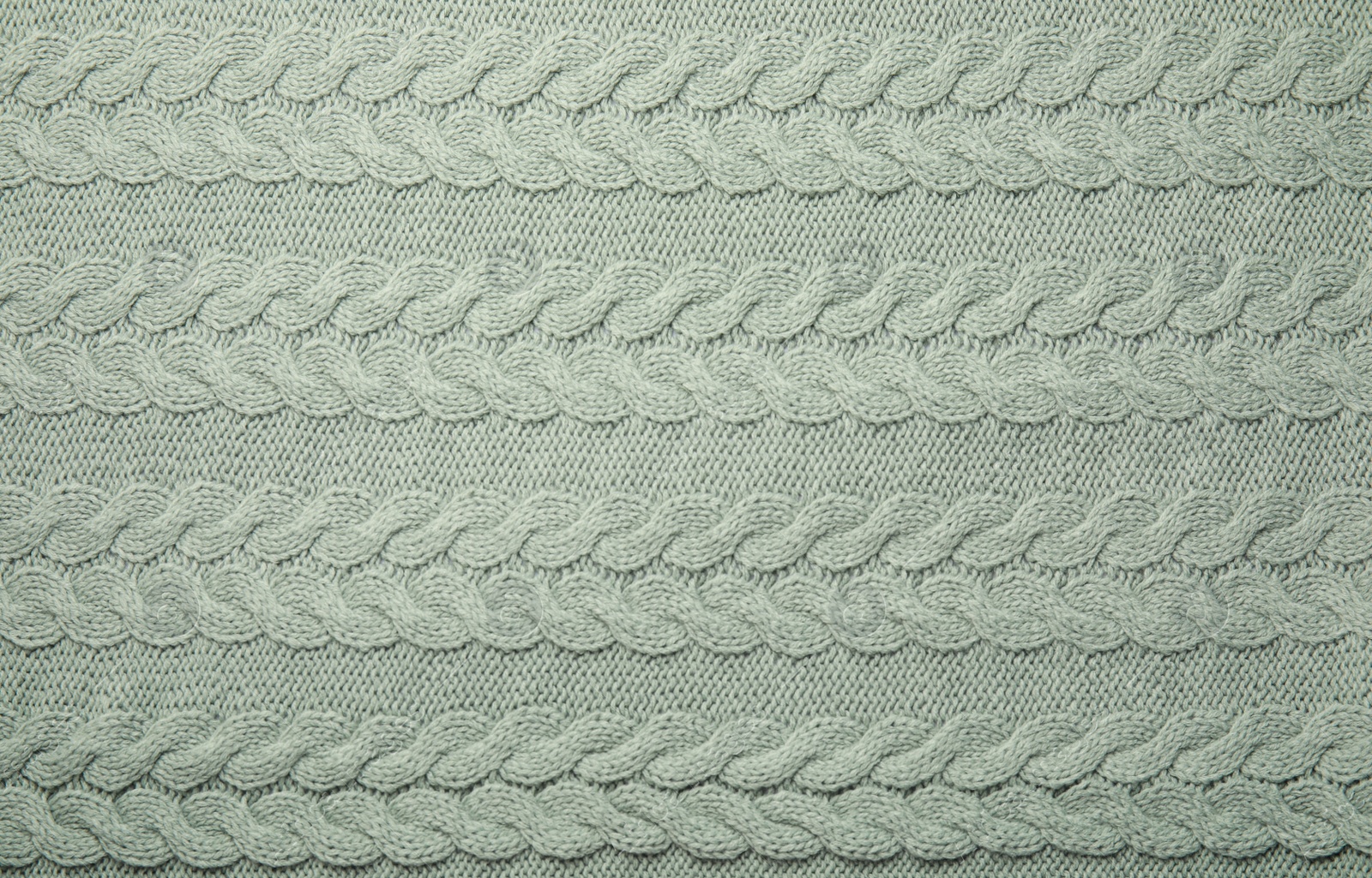 Photo of Soft knitted plaid as background, top view