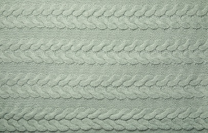 Photo of Soft knitted plaid as background, top view