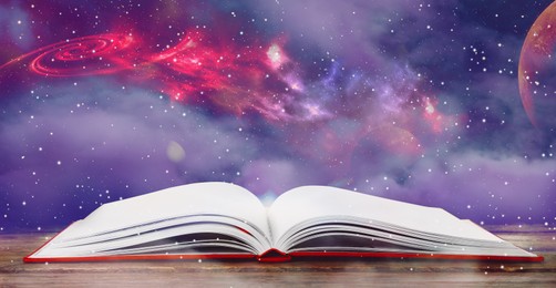 Image of Open book with glitter overlay and beautiful universe on background