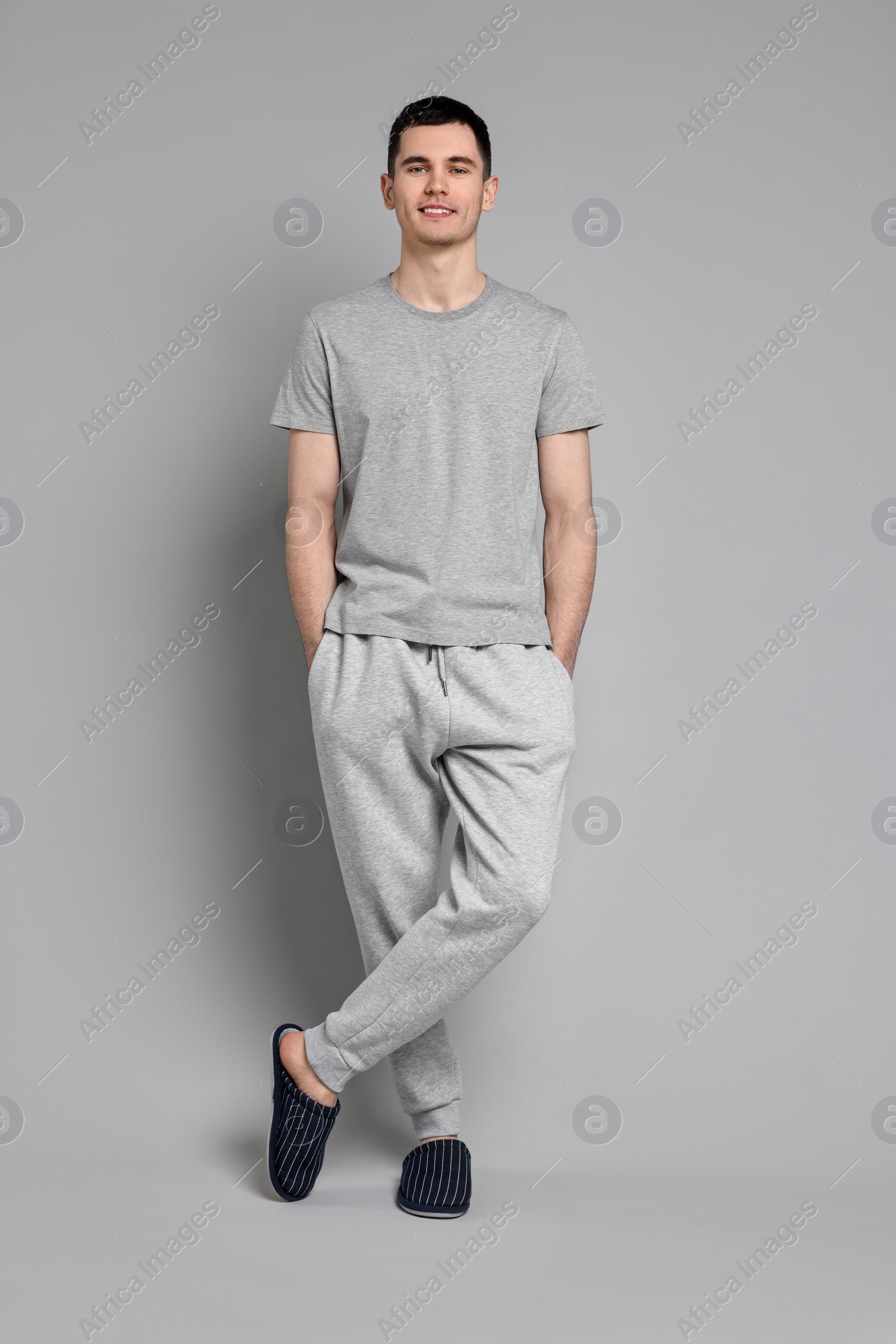 Photo of Happy man in pyjama on grey background