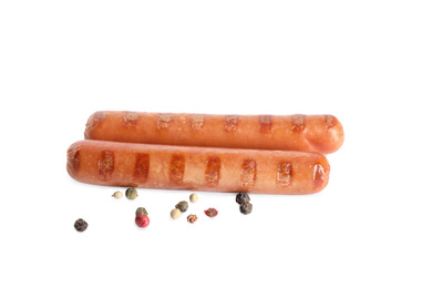 Photo of Tasty grilled sausages and peppercorns on white background