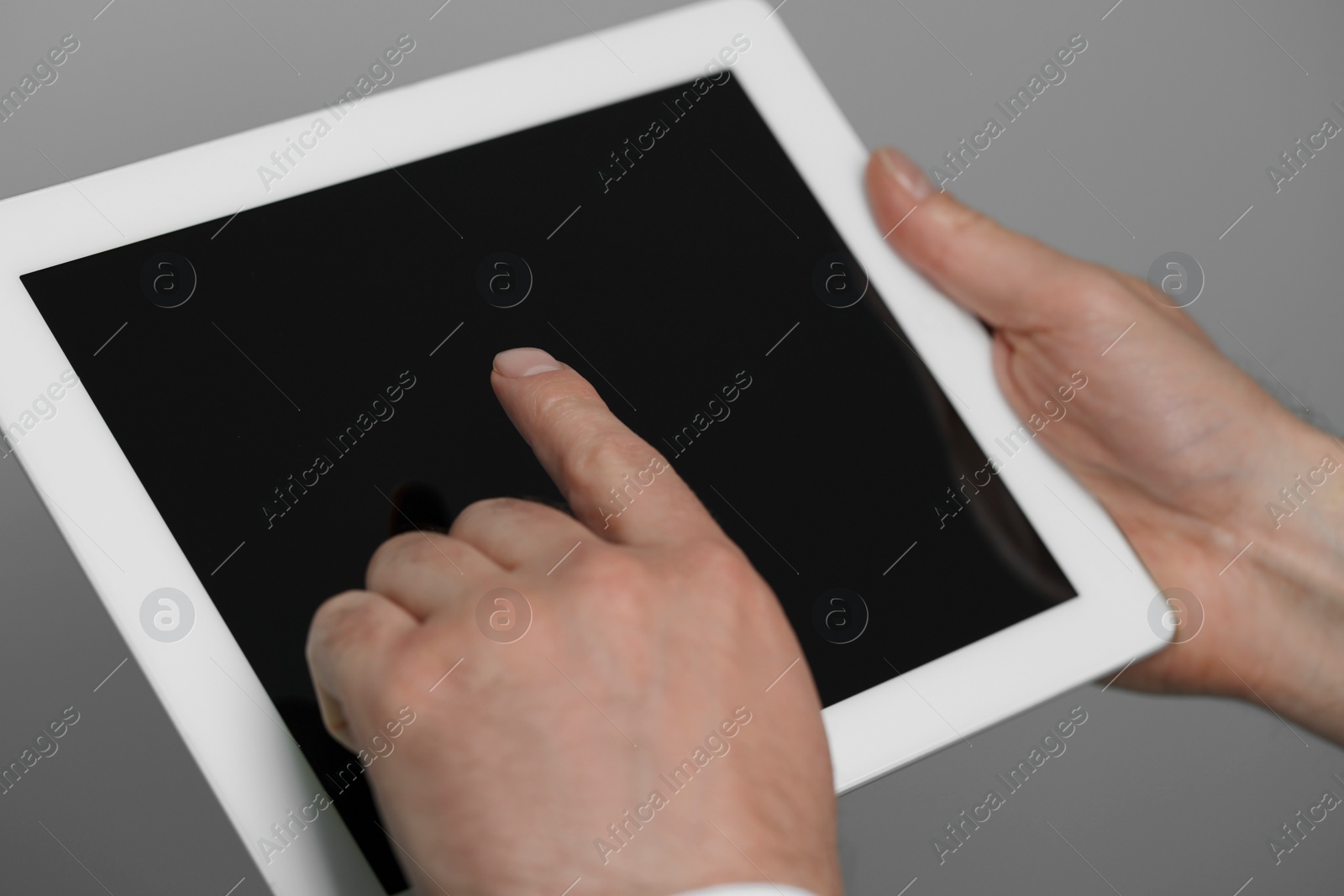 Photo of Closeup view of man using new tablet indoors