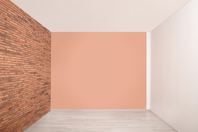 Empty room with different walls, white door and laminated floor