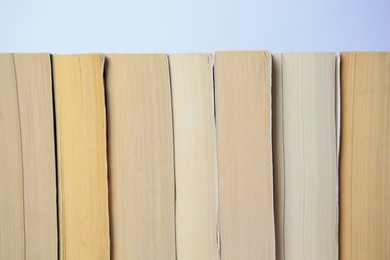 Photo of Collection of different books on light background, closeup