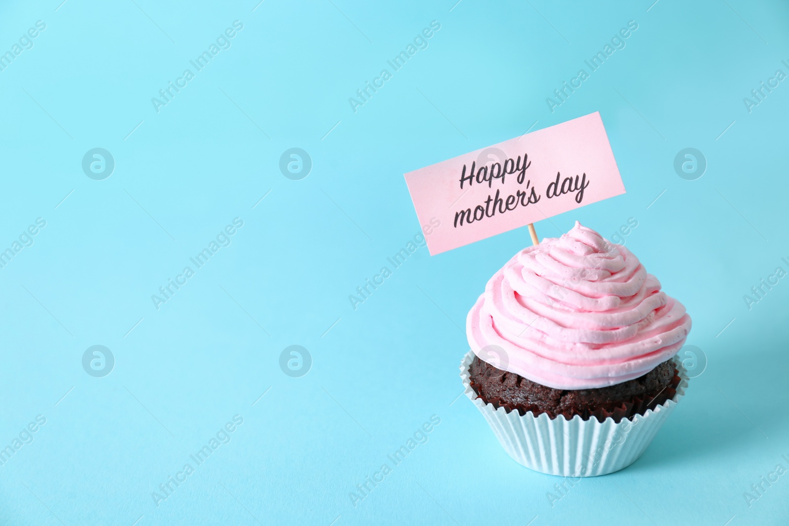 Photo of Topper with words HAPPY MOTHER'S DAY in cupcake on color background