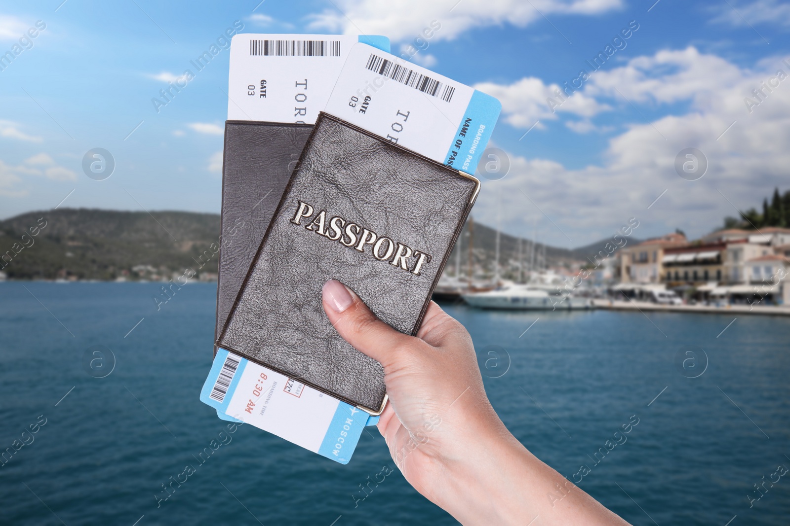 Image of Woman holding passport with tickets and beautiful view of boats in sea near shore on background