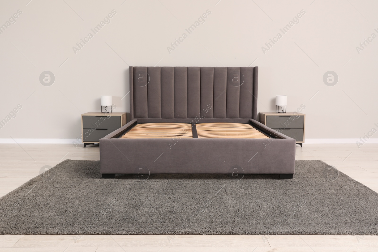 Photo of Comfortable bed with storage space for bedding under slatted base in room