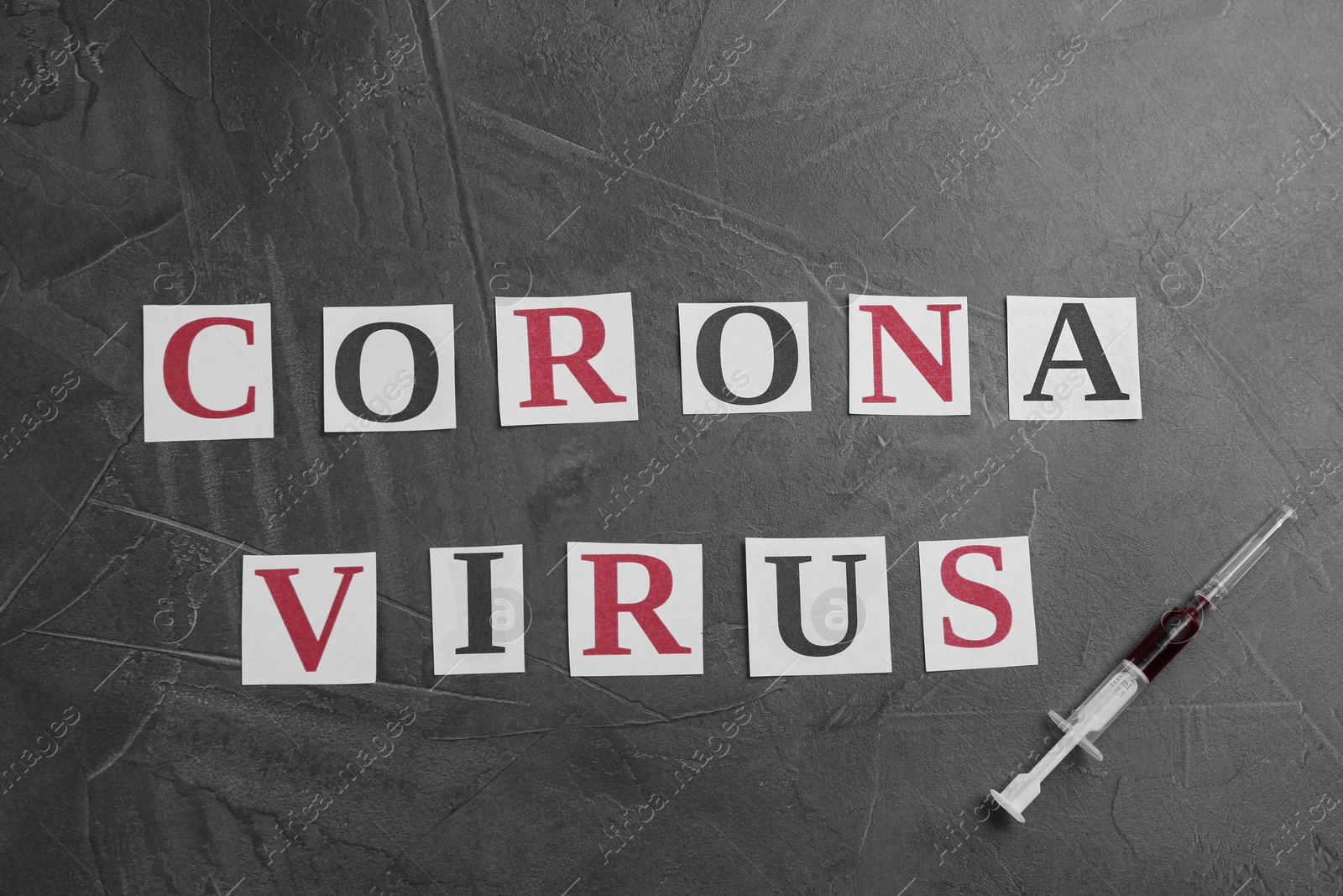 Photo of Words CORONA VIRUS and syringe on grey stone background, flat lay