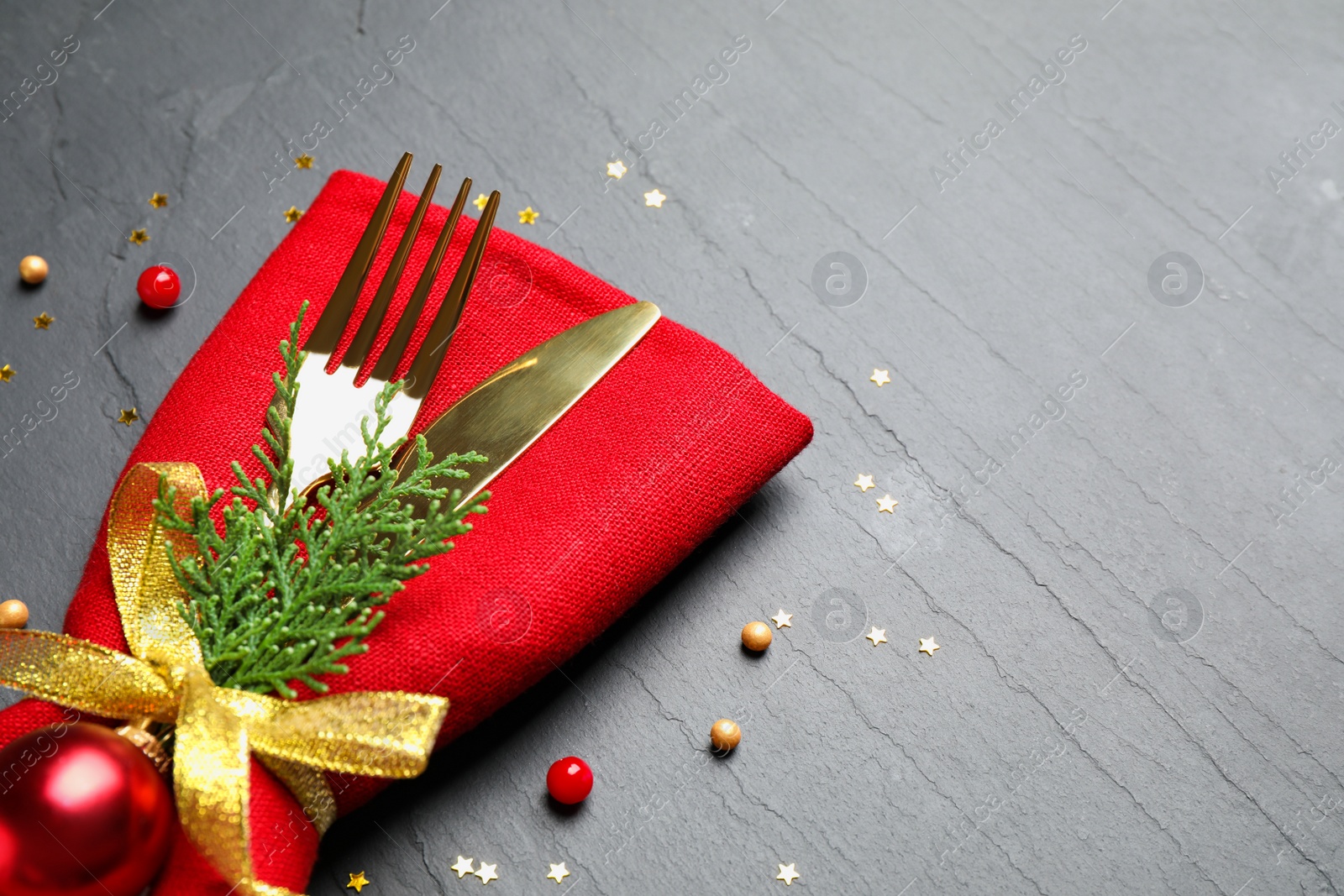 Photo of Cutlery set on grey textured table, space for text. Christmas celebration