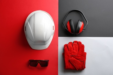 Photo of Flat lay composition with safety equipment on color background