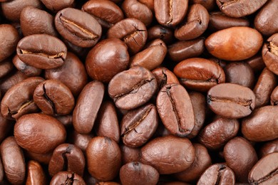 Aromatic roasted coffee beans as background, top view