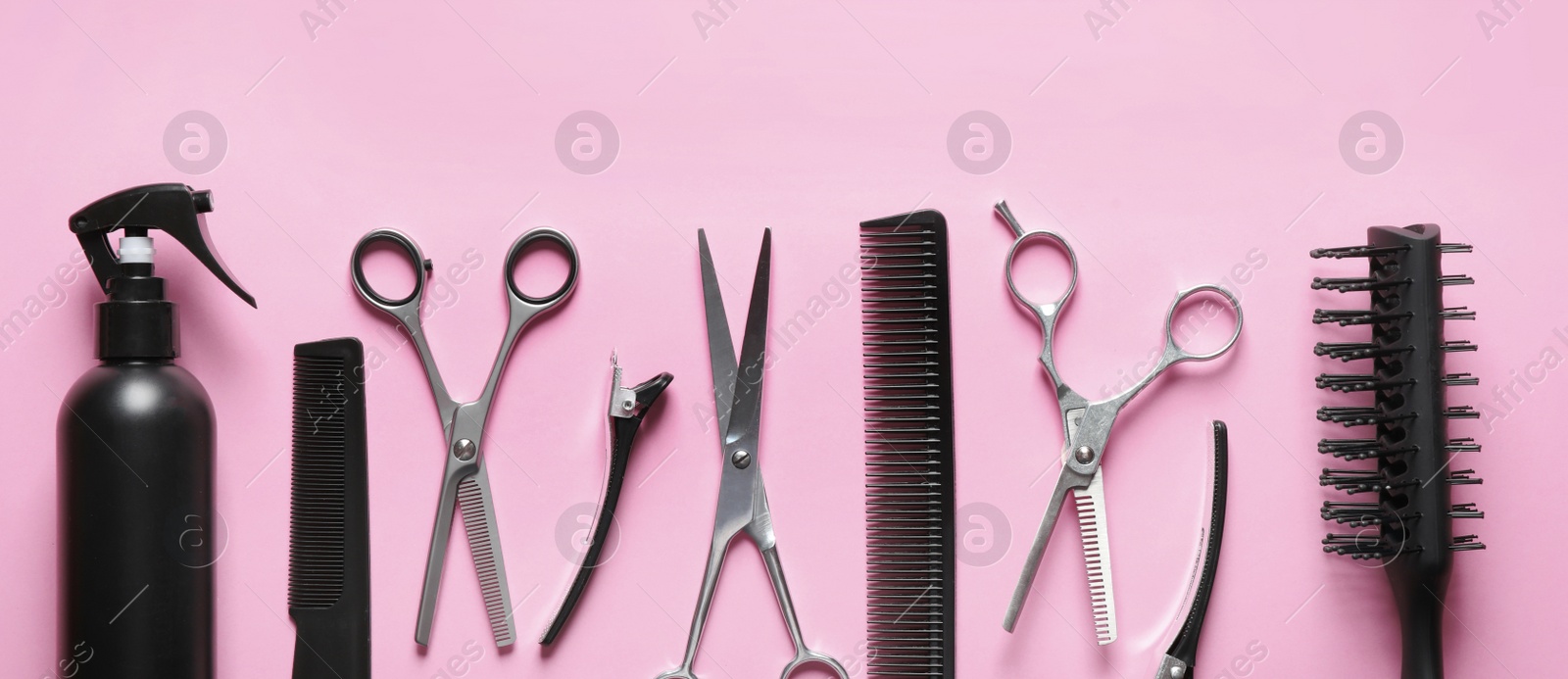 Image of Set with scissors and other hairdresser's accessories on pink background, flat lay. Banner design