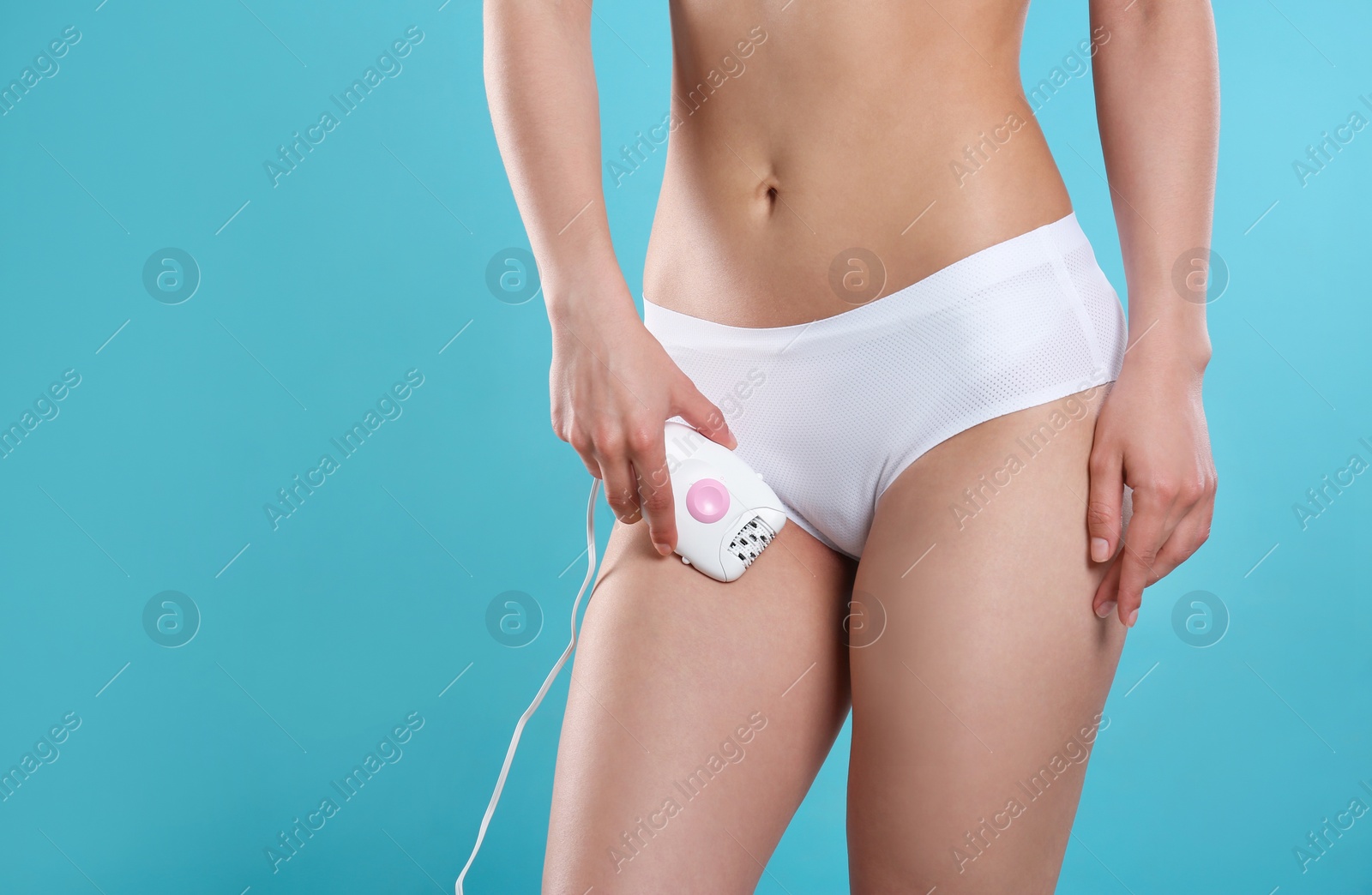 Photo of Woman doing bikini epilation procedure on blue background, closeup. Space for text