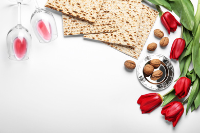 Photo of Flat lay composition with matzos on white background, space for text. Passover (Pesach) celebration