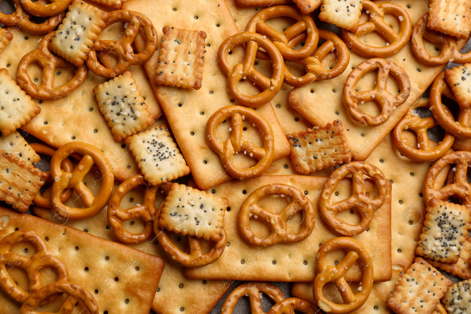 Photo of Many delicious crackers as background, top view