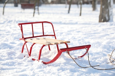 Photo of Empty sleigh in snowy park on sunny winter day