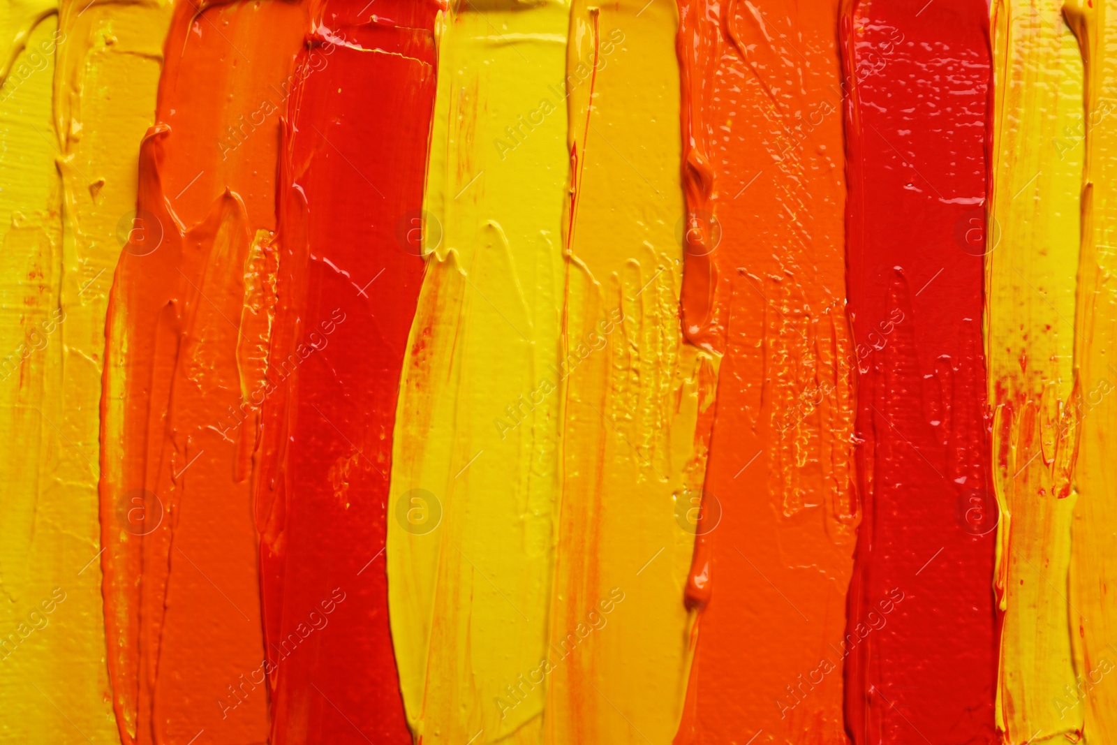 Photo of Strokes of colorful oil paints as background, closeup