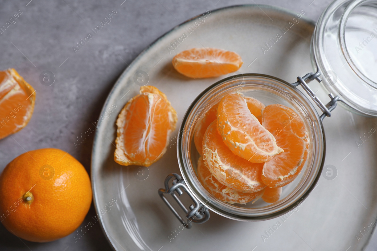 Photo of Fresh ripe tangerines on grey table, flat lay