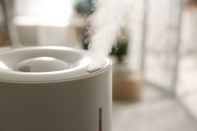 Modern humidifier indoors, closeup. Space for text