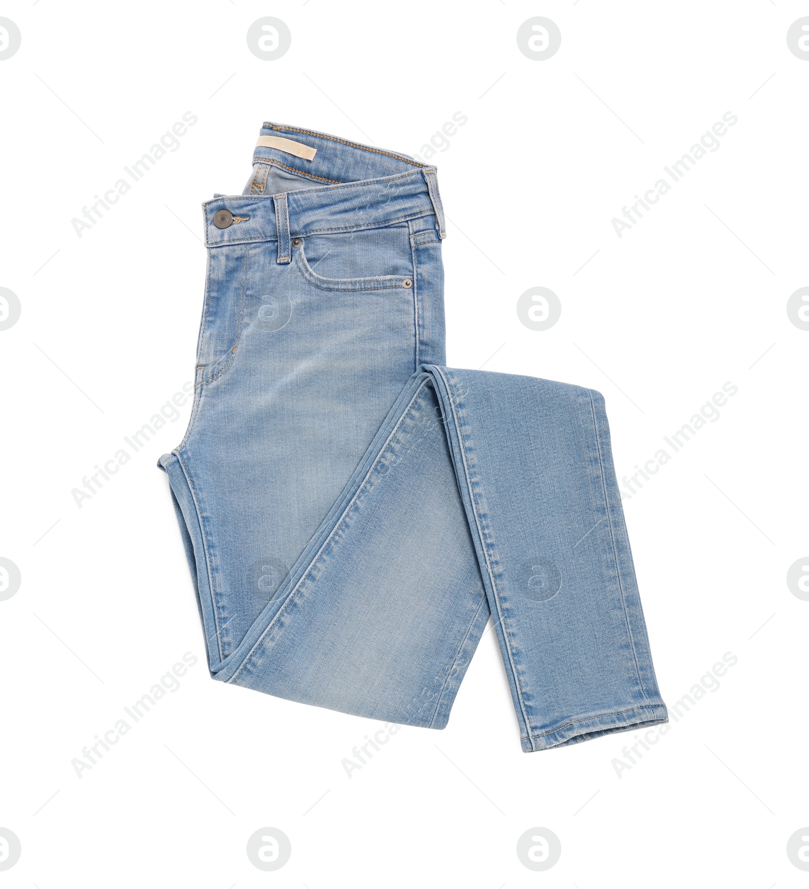 Photo of Stylish light blue jeans isolated on white, top view