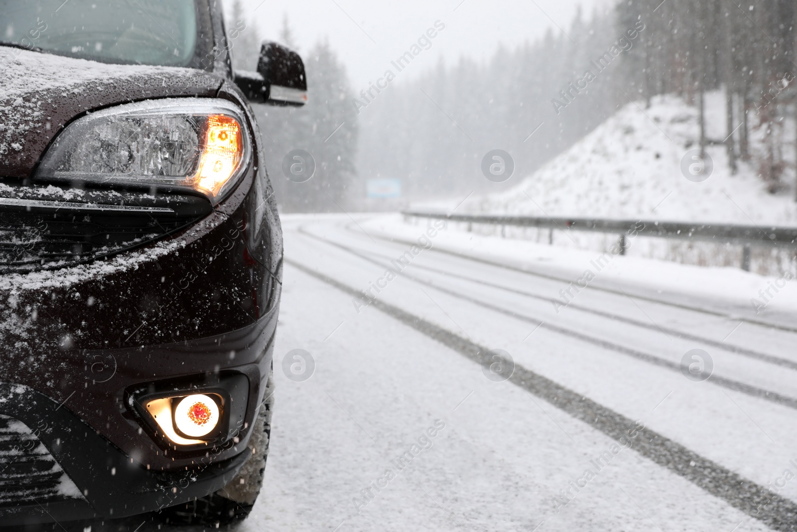 Photo of Country road with car on snowy winter day. Space for text