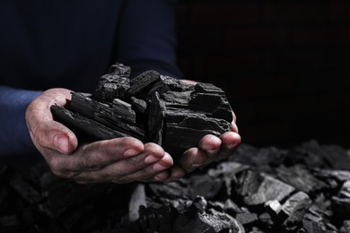 Photo of Man with handful of coal, closeup view
