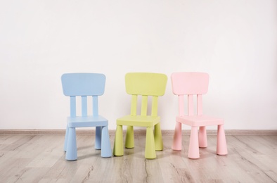 Photo of Different color chairs in child room. Space for text