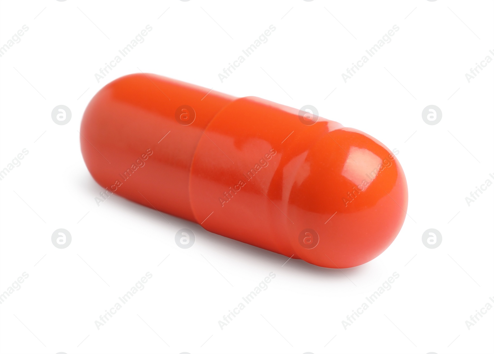 Photo of One orange pill on white background. Medicinal treatment