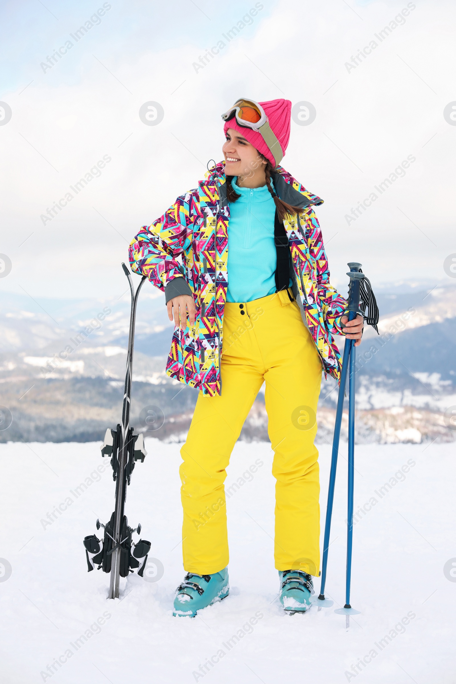 Photo of Young skier wearing winter sport clothes outdoors