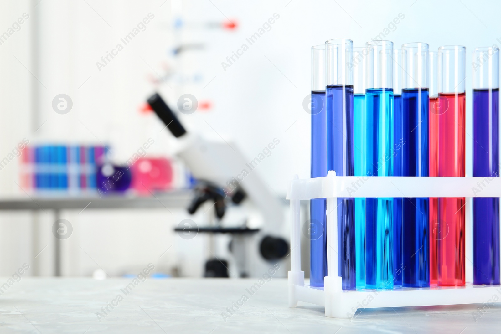 Photo of Test tubes with samples on table in chemistry laboratory. Space for text