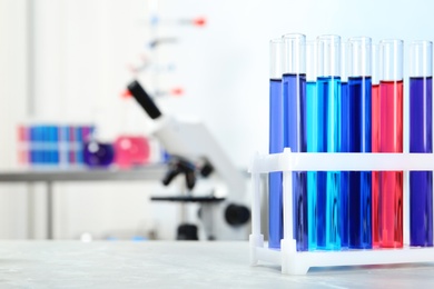 Test tubes with samples on table in chemistry laboratory. Space for text