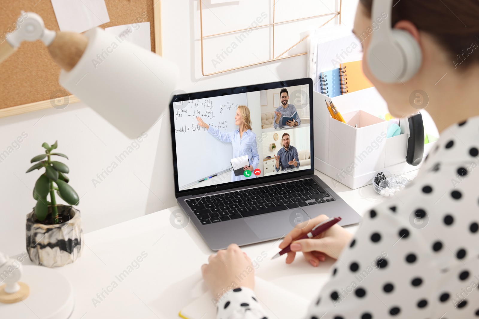 Image of E-learning. Woman writing during online class at home