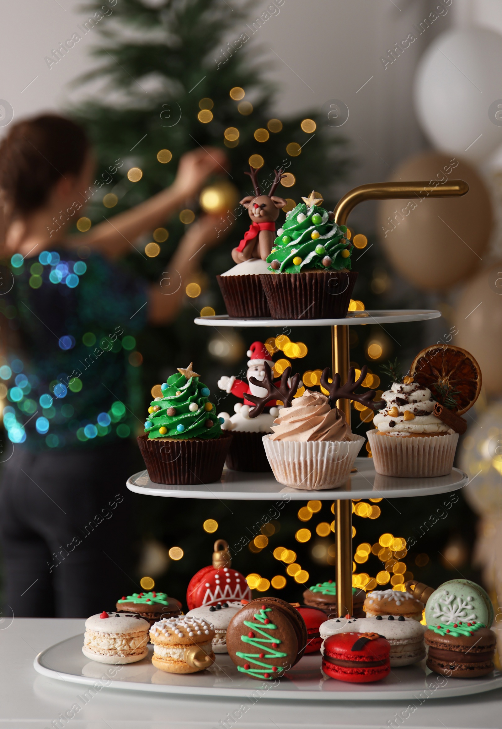 Photo of Many different Christmas cupcakes on white table indoors