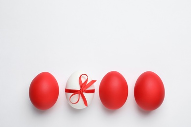 Photo of Composition of painted red Easter eggs on white background, top view