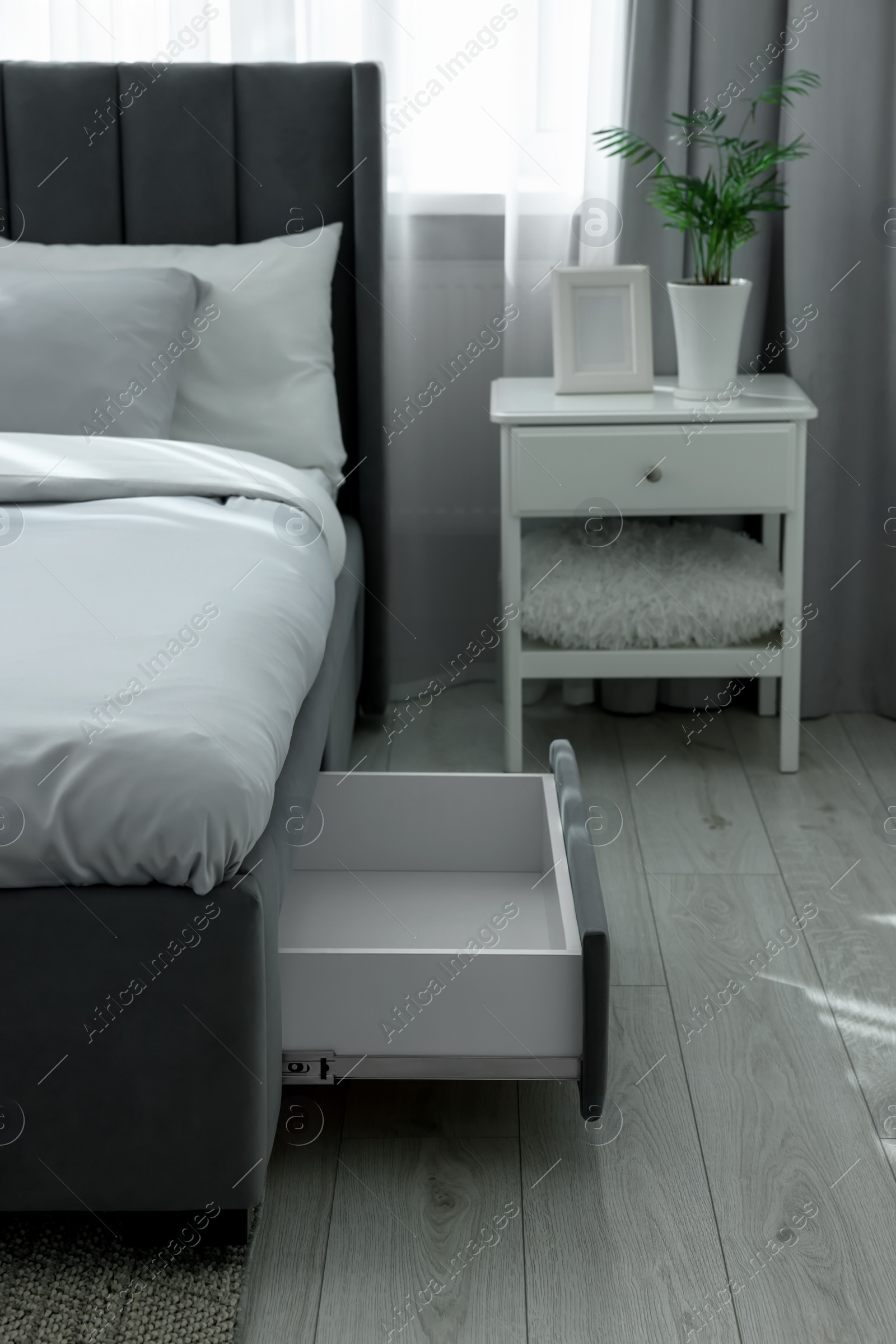 Photo of Storage drawer for bedding under modern bed in room