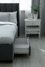 Photo of Storage drawer for bedding under modern bed in room