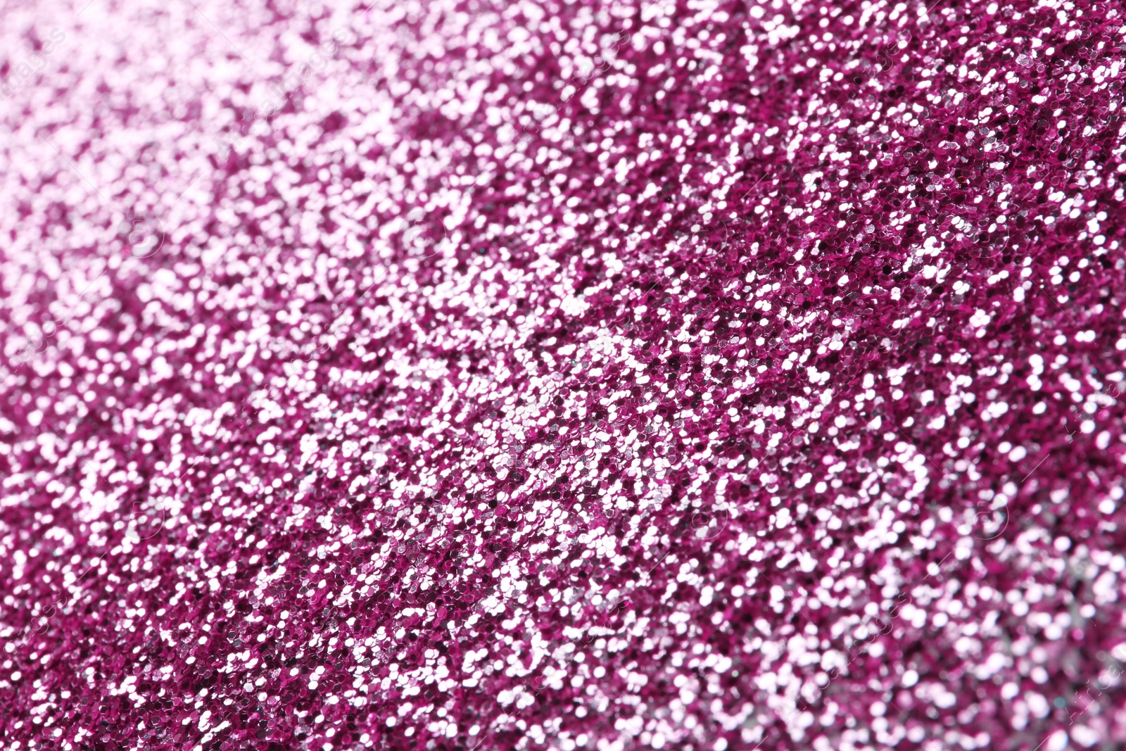 Photo of Closeup view of sparkling pink glitter background