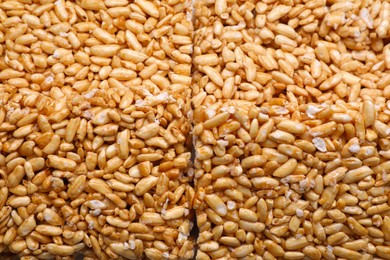 Photo of Puffed rice bars (kozinaki) as background, top view